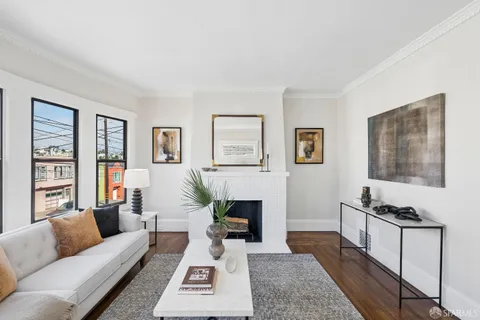 a view of a hallway with fireplace and a potted plant