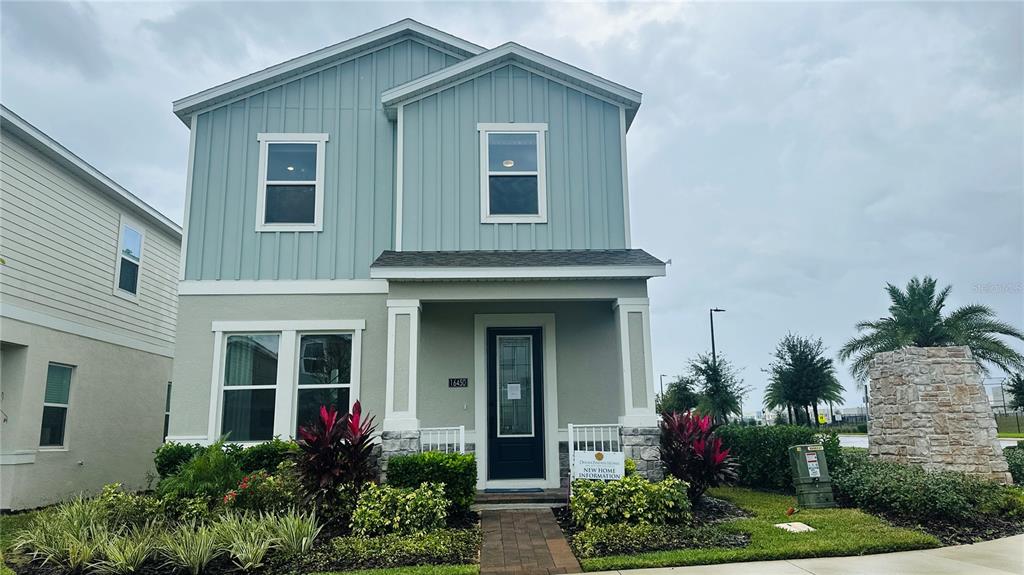 a front view of a house with plants
