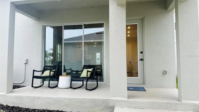 a bedroom with furniture and a potted plant