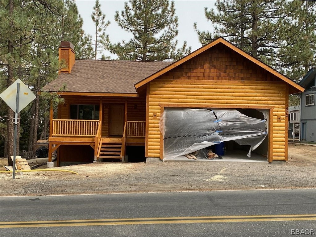 Undisclosed Address Big Bear City, CA 92314 - Photo 1 of 1 a front view of a house with a yard and garage