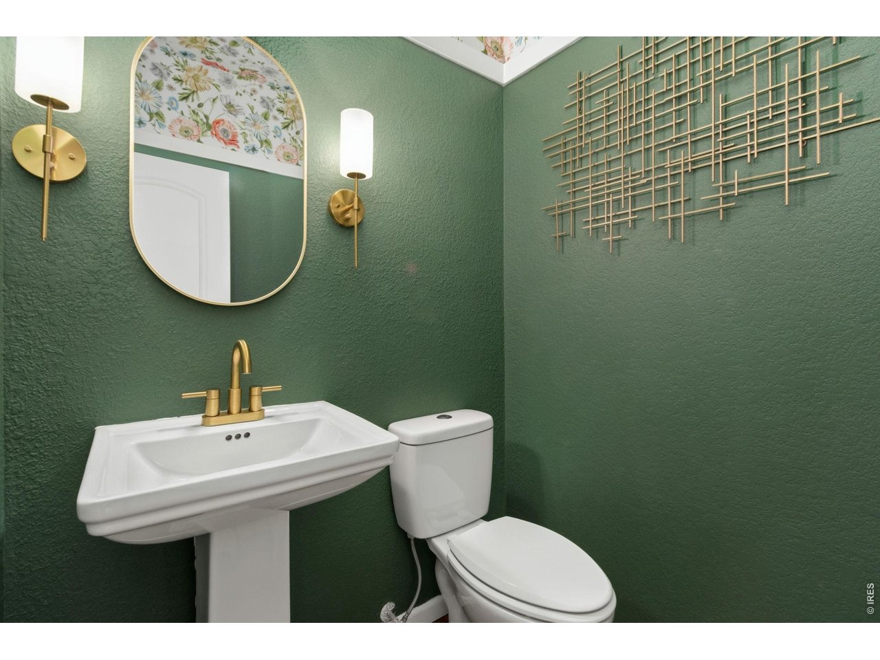 6837 McClellan Road Wellington, CO 80549 - Photo 11 of 23 A beautifully designed powder room adds a touch of personality with rich color, modern fixtures, and designer finishes.