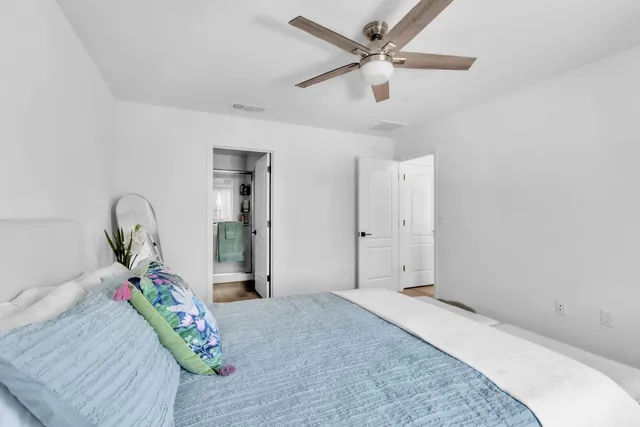 a bedroom with a bed and a chandelier