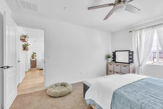 a bedroom with a bed and a window