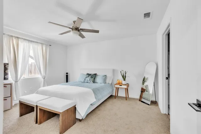 a bedroom with a bed and a table