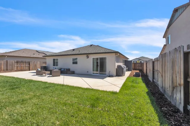 a front view of a house with patio and garden