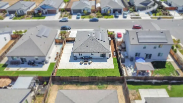 an aerial view of house with yard swimming pool and outdoor seating