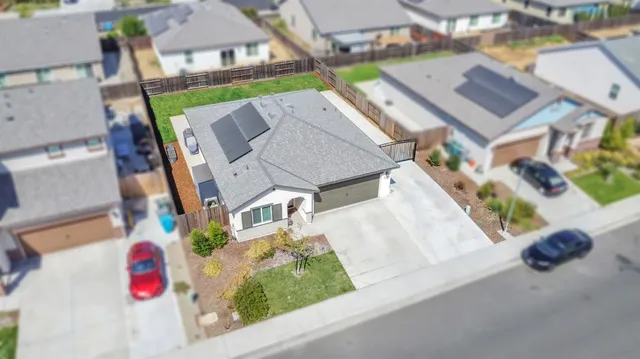 an aerial view of multiple houses with yard