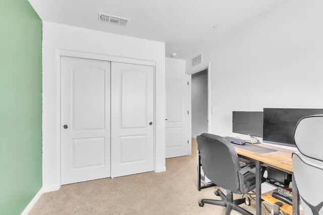 a view of a workspace with furniture and wooden floor