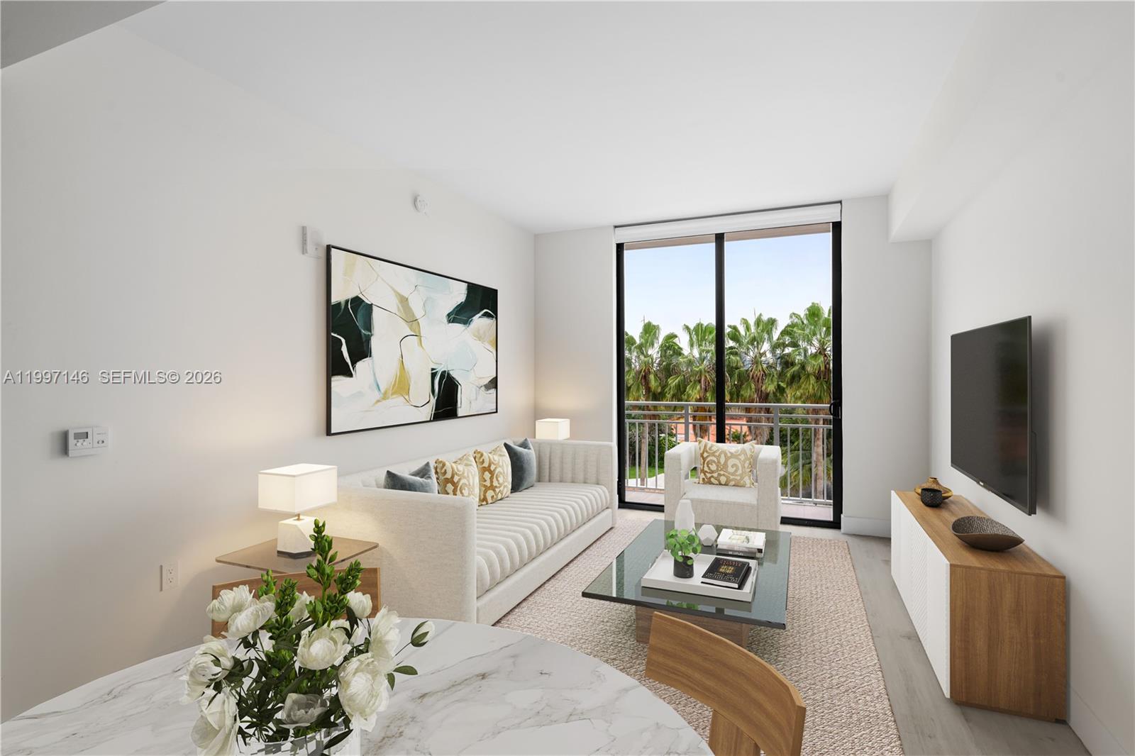 1601 Southwest 32nd Avenue, Unit 403 Miami, FL 33145 - Photo 2 of 4 a living room with furniture a flat screen tv and a large window
