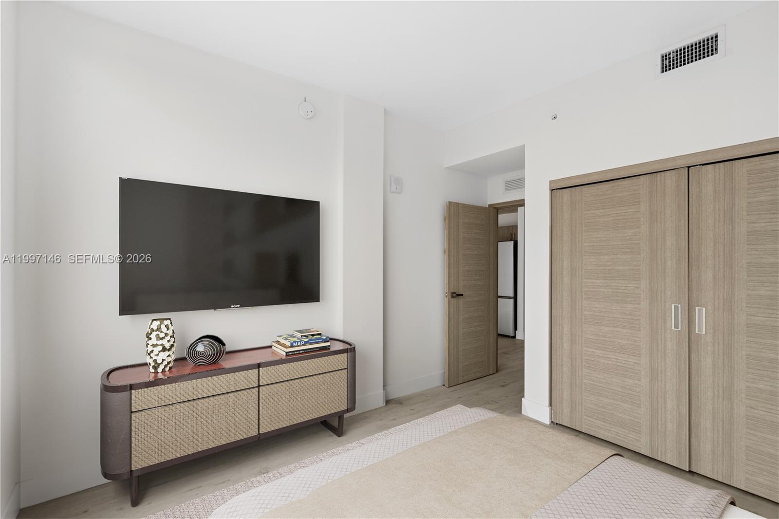 1601 Southwest 32nd Avenue, Unit 403 Miami, FL 33145 - Photo 3 of 4 a living room with furniture and a flat screen tv