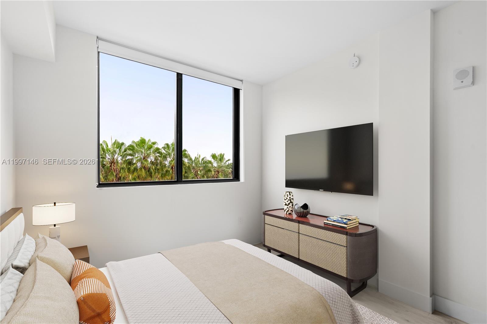 1601 Southwest 32nd Avenue, Unit 403 Miami, FL 33145 - Photo 4 of 4 a bedroom with a bed and a flat screen tv