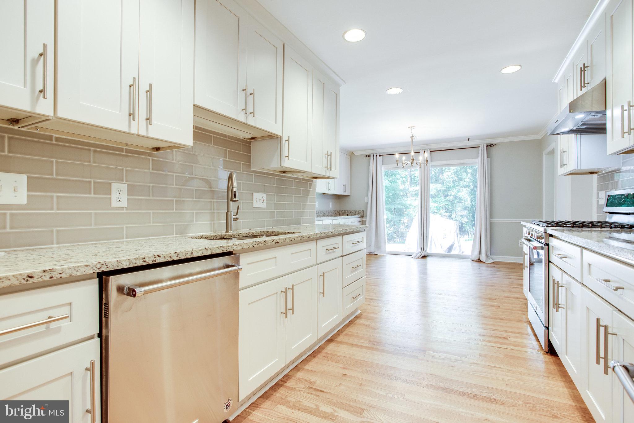 8500 Brook Road McLean, VA 22102 - Photo 12 of 44 a kitchen with granite countertop a sink and cabinets