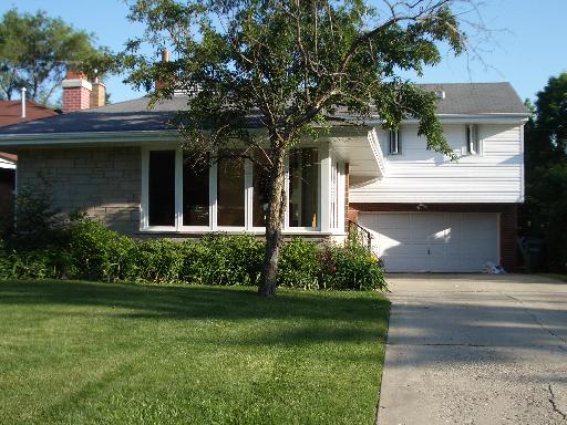 217 Voltz Road Northbrook, IL 60062 - Photo 1 of 1 a front view of a house with a garden and plants