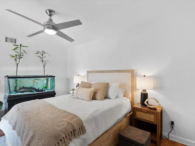 a bedroom with a large bed and a large window