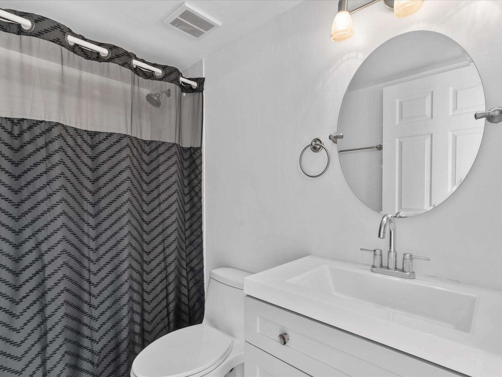 4025 Village Drive, Unit C Delray Beach, FL 33445 - Photo 20 of 32 a bathroom with a sink a toilet and shower