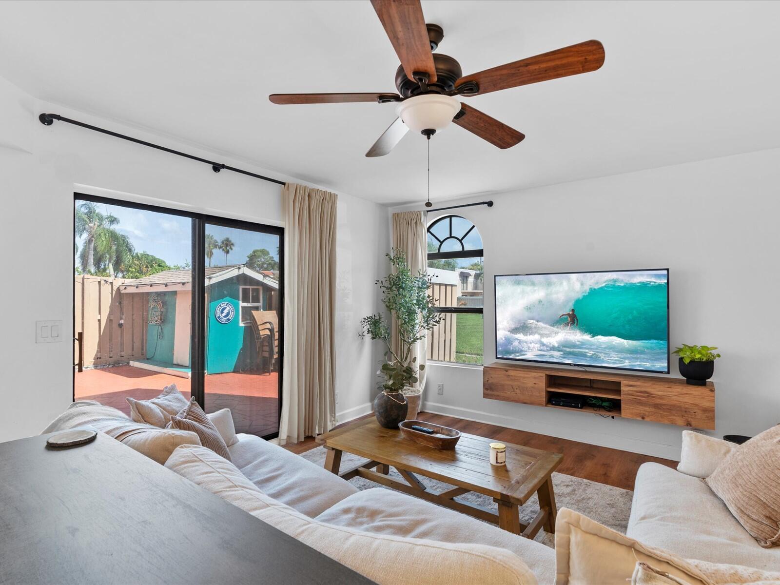 4025 Village Drive, Unit C Delray Beach, FL 33445 - Photo 2 of 32 a living room with furniture and a flat screen tv