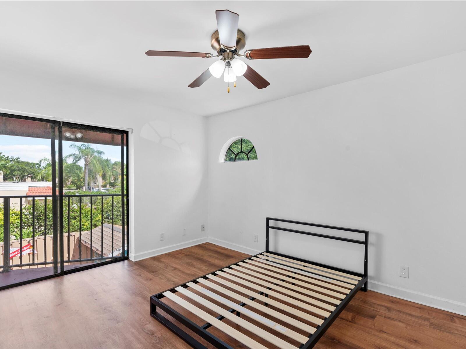 4025 Village Drive, Unit C Delray Beach, FL 33445 - Photo 21 of 32 a bedroom with a bed and a window