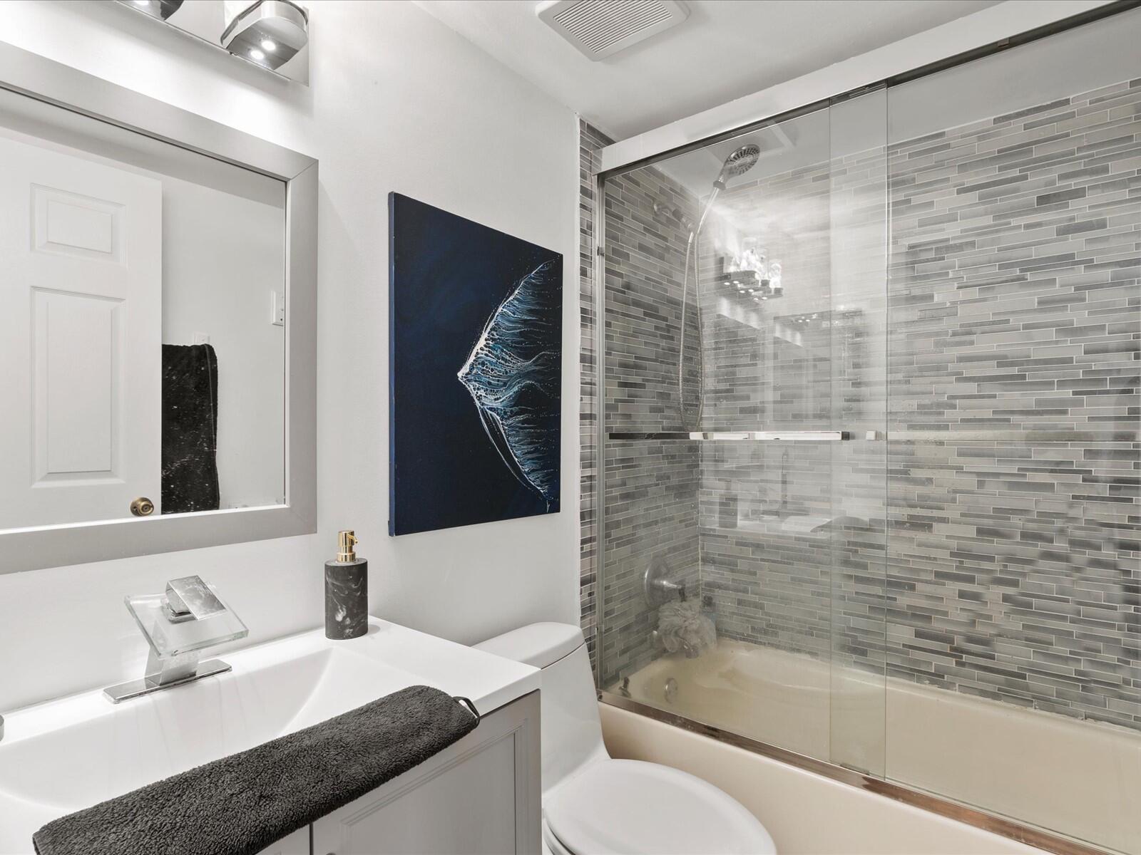 4025 Village Drive, Unit C Delray Beach, FL 33445 - Photo 27 of 32 a bathroom with a granite countertop sink toilet and shower