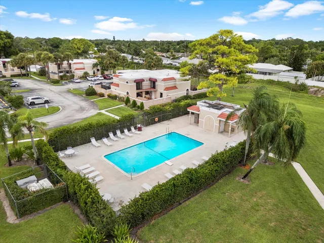 an aerial view of a house with a garden and lake view