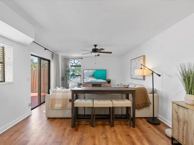 a living room with furniture and a wooden floor