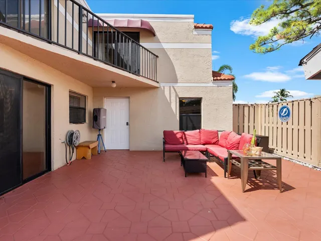 a view of a patio with a table and chairs