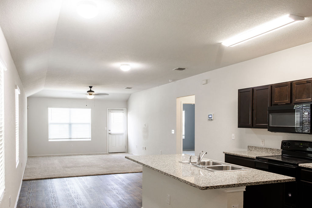 14915 Talus Road Manor, TX 78653 - Photo 18 of 20 An open floorplan seamlessly connects the functional kitchen to a spacious living area.