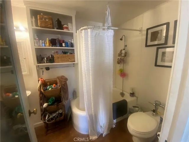 a bathroom with a toilet and a shower