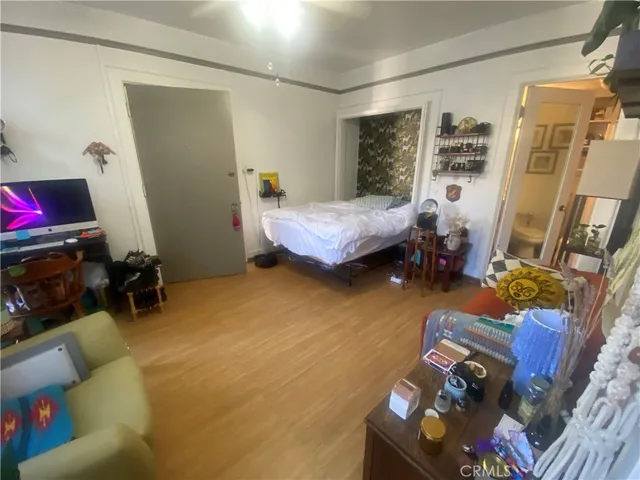 a bedroom with furniture and a flat screen tv