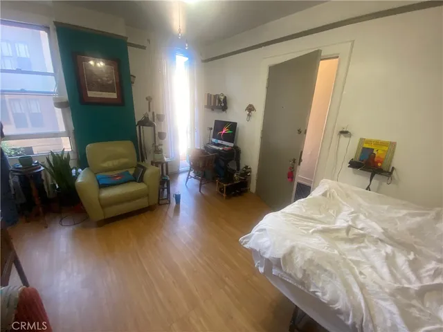 a bedroom with a bed and a chair