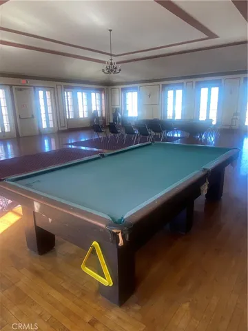 a room with pool table and windows