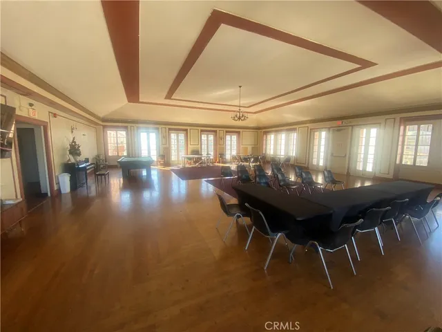 a view of a room with furniture and wooden floor