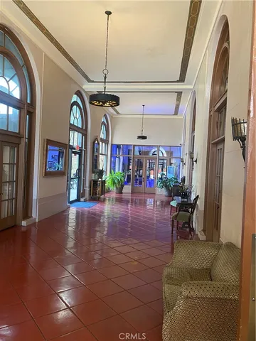 a living room with lots of furniture and a chandelier