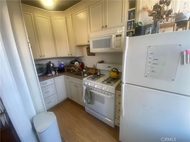 a kitchen with a white cabinets and white appliances
