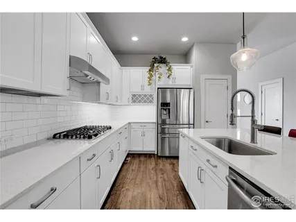 a kitchen with sink cabinets and stainless steel appliances