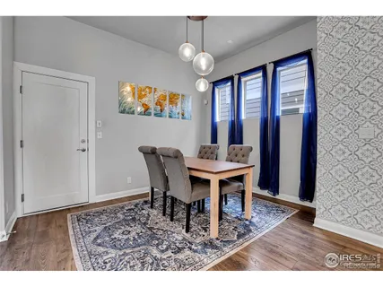 a view of a dining room with furniture wooden floor and chandelier