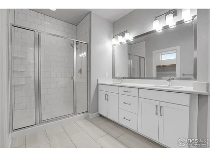 a bathroom with a double vanity sink and a mirror