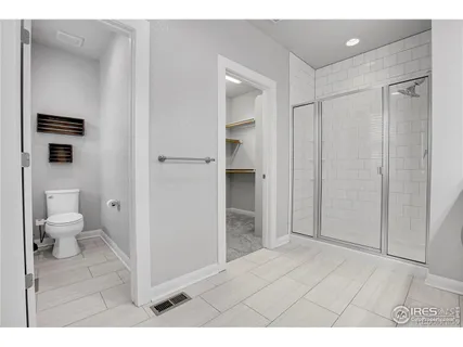 a bathroom with a shower and a toilet