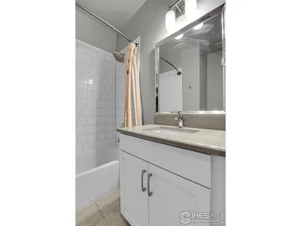 a bathroom with a sink a shower and a mirror