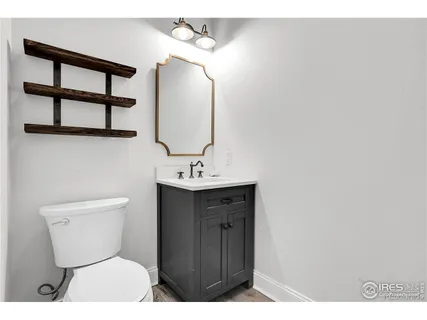 a bathroom with a toilet a sink and mirror