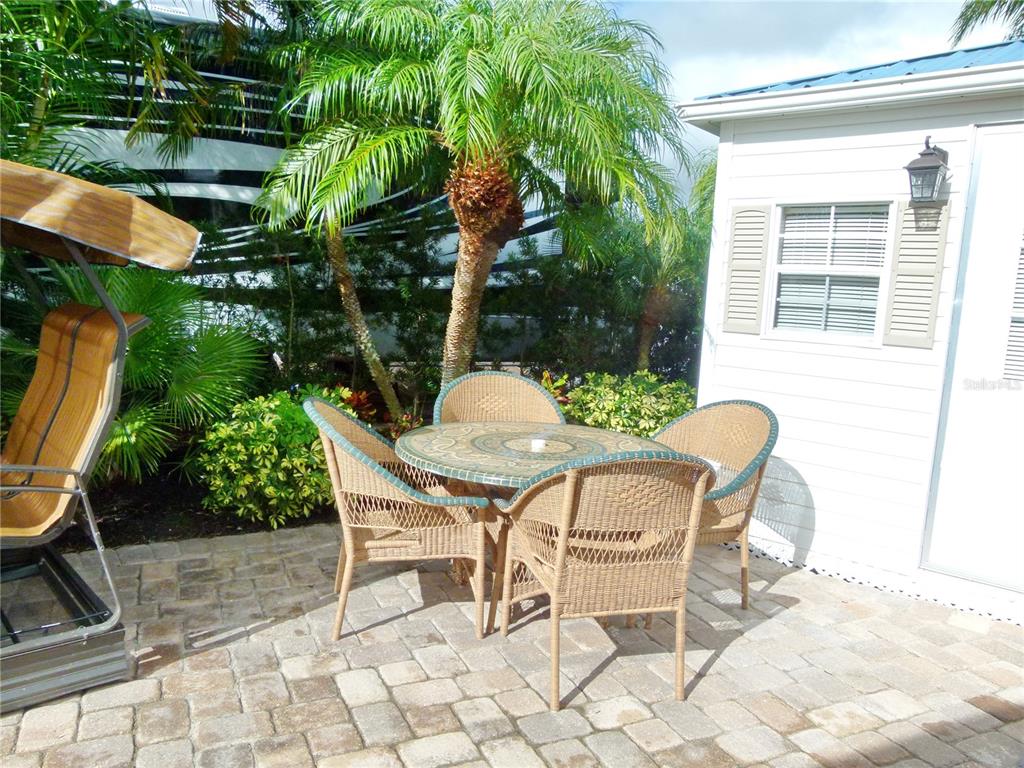 537 Southwest 40th Cove, Unit 73 Okeechobee, FL 34974 - Photo 12 of 23 a patio with table and chairs and potted plants