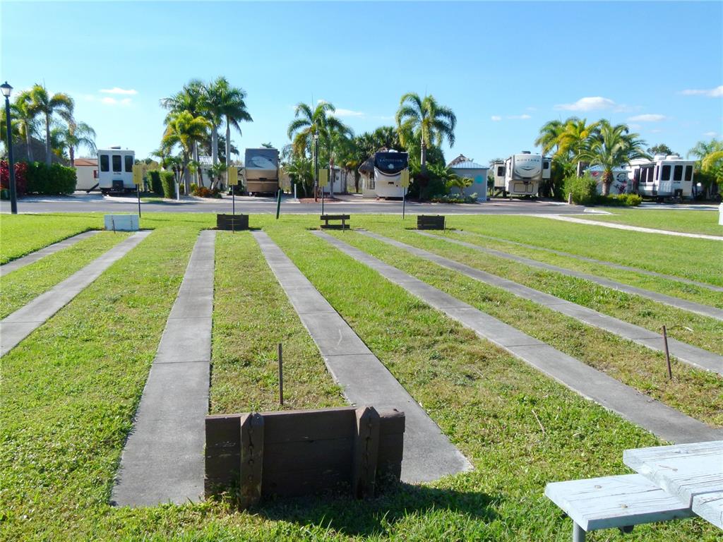 537 Southwest 40th Cove, Unit 73 Okeechobee, FL 34974 - Photo 18 of 23 a swimming pool with outdoor seating and yard
