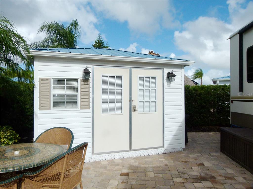 537 Southwest 40th Cove, Unit 73 Okeechobee, FL 34974 - Photo 5 of 23 a view of a patio with table and chairs and potted plants
