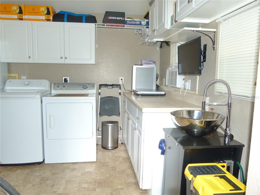 537 Southwest 40th Cove, Unit 73 Okeechobee, FL 34974 - Photo 7 of 23 a kitchen with a stove and a sink