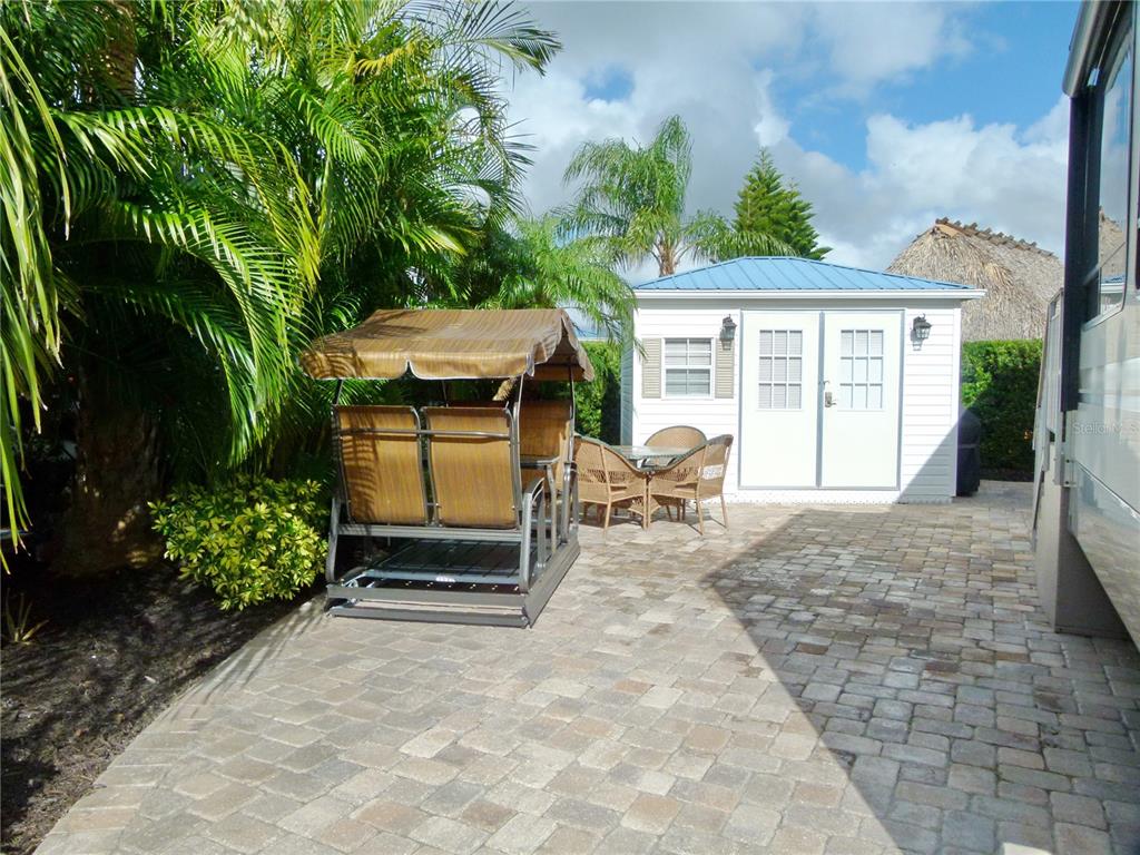 537 Southwest 40th Cove, Unit 73 Okeechobee, FL 34974 - Photo 8 of 23 a backyard of a house with yard and outdoor seating