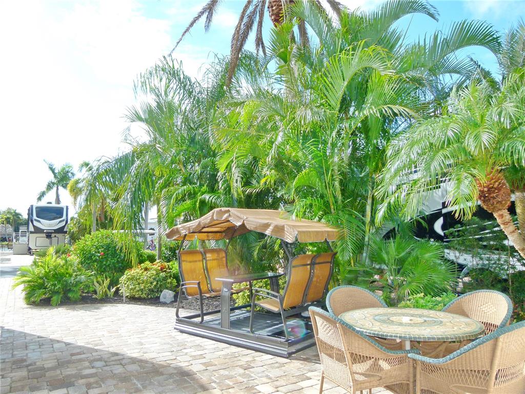 537 Southwest 40th Cove, Unit 73 Okeechobee, FL 34974 - Photo 9 of 23 a view of a chair and table in backyard