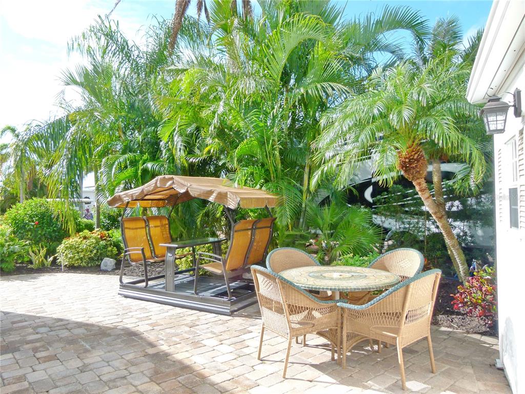 537 Southwest 40th Cove, Unit 73 Okeechobee, FL 34974 - Photo 10 of 23 a view of a chairs and table in backyard