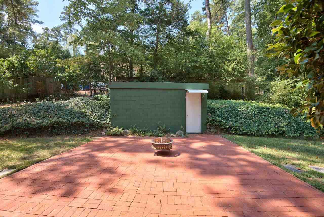 1207 Woodburn Road Durham, NC 27705 - Photo 21 of 25 Large, flat brick patio for backyard entertaining right outside your Dining Room door! Wait. What's the groovy green outbuilding? Oh, just the bomb shelter. Bonafide. Certified. B. O. M. B. Shelter. In your own backyard. Imagine the possibilities... Great Back Patio!