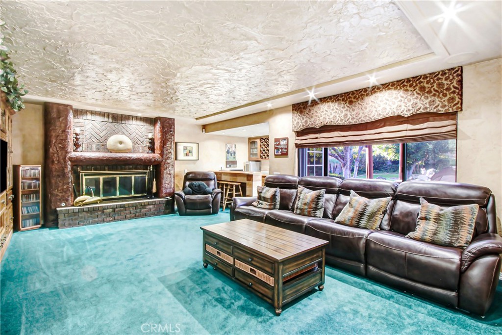 7954 Thoroughbred Street Rancho Cucamonga, CA 91701 - Photo 12 of 63 a living room with furniture and a fireplace