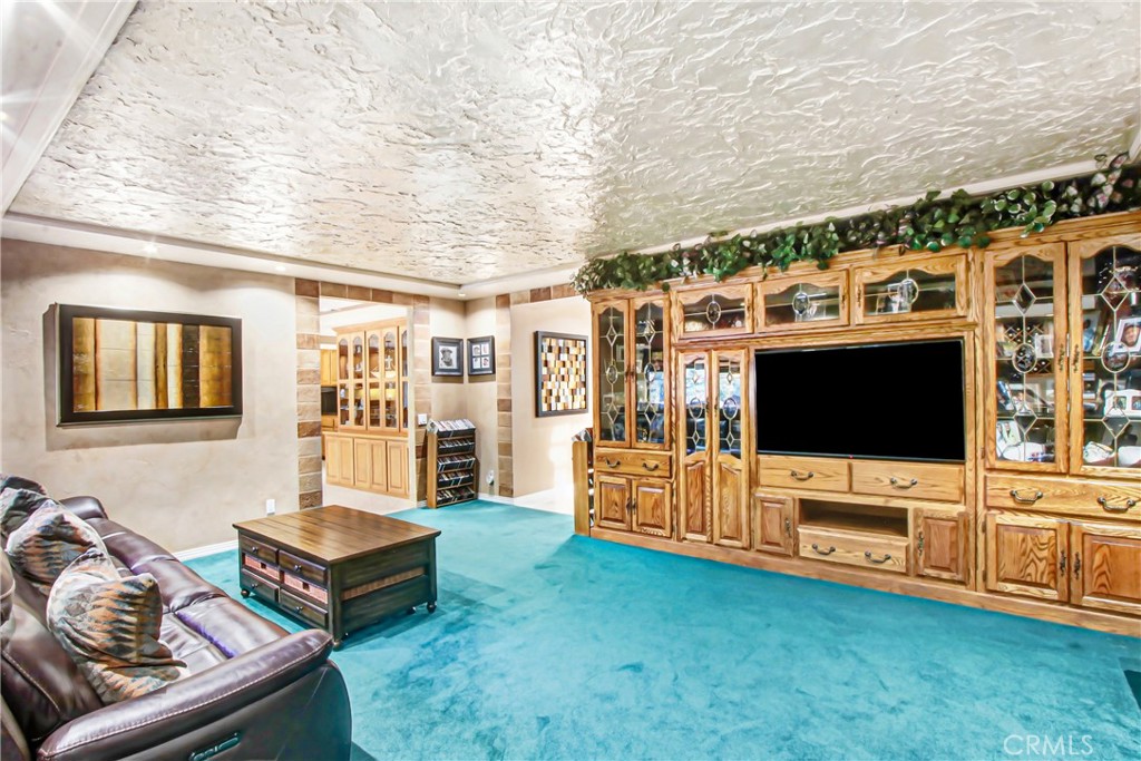 7954 Thoroughbred Street Rancho Cucamonga, CA 91701 - Photo 15 of 63 a living room with furniture and a flat screen tv