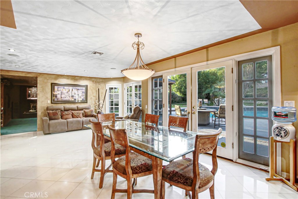 7954 Thoroughbred Street Rancho Cucamonga, CA 91701 - Photo 23 of 63 a dining room with furniture wooden floor and a chandelier